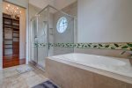 En-suite bath with separate walk-in closet and dressing area